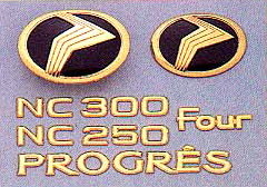 Gold emblem (model symbol mark) (car name logograph (for rear))(Grademark (for rear) NC250/NC300) (Four) (model symbol mark (for rear))