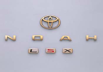 Gold emblem (the Toyota symbol (for rear), car name logograph (for rear), grademark (L S X))